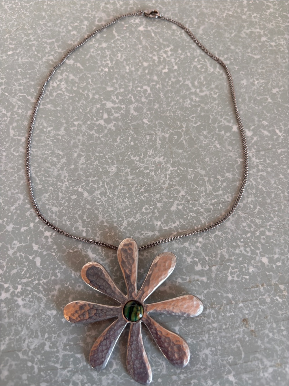 St. Justin stamped Dahlia pendant on silver chain